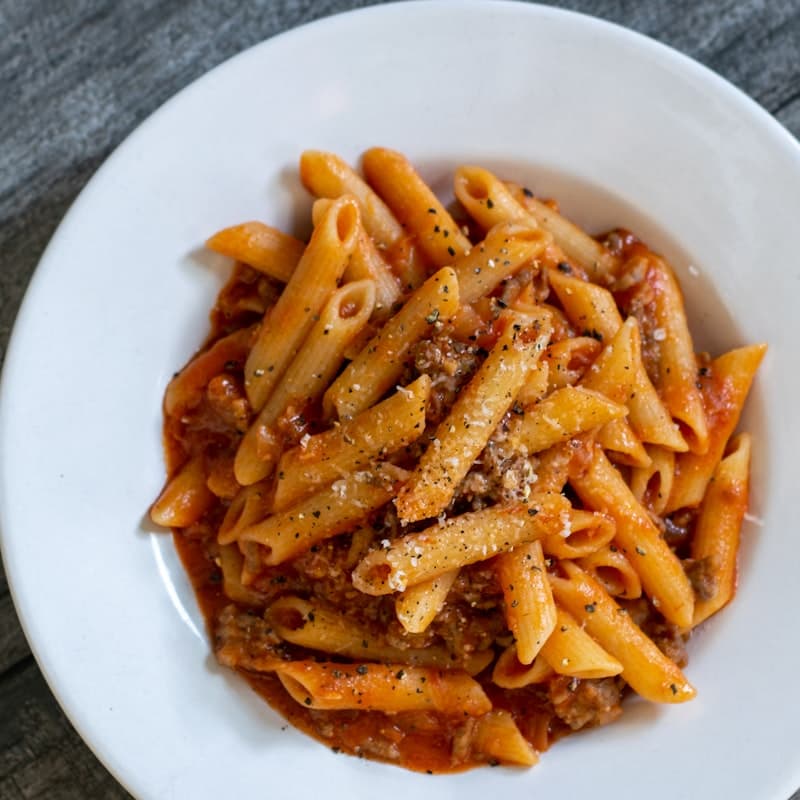 Bord pappardelle met donkere ossenstaart ragu en geschaafde Parmezaan